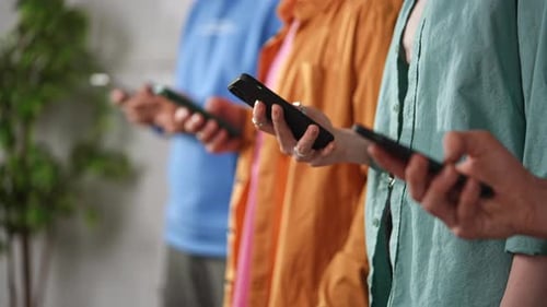 Group of People Engaging with Smartphones in Casual Setting