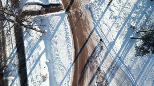 A Breathtaking Aerial View Showcases a Winter Road Surrounded By a Snowy Landscape and a Slightly