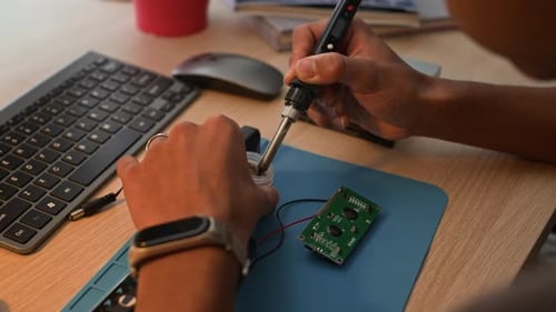 Soldering Circuit Board at Desk