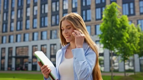 Happy Woman Talking on Phone in Urban Setting