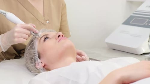 Woman Receiving Cosmetic Treatment in Clinic