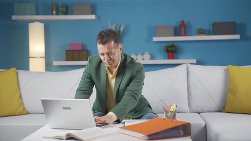 Home office worker man working on laptop.