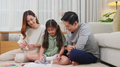 Family Drawing Together on Living Room Floor
