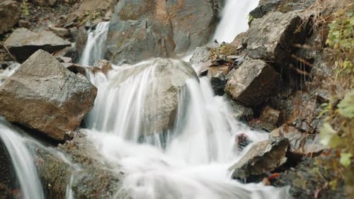 Close Up of Stone Boulders Washed By a Rapid Stream in the Mountains in Autumn