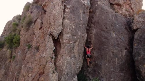 Climbing woman in the mountain. Drone view of climber sportsmen.Physical activity in the countryside