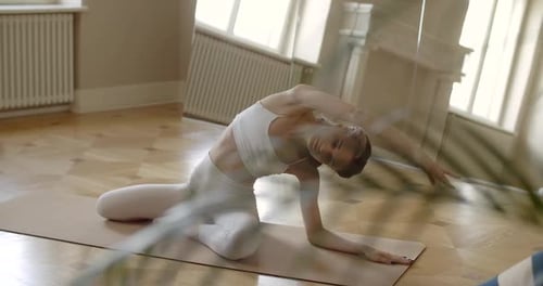 Group of Young Fit Women Does Exercises in a Yoga Studio