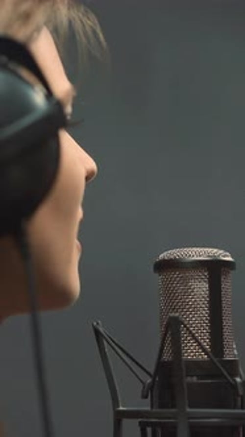 Vocalist Sings Song with Microphone in Recording Studio