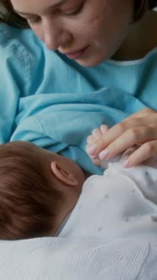 Mother Holds Newborn Baby in Hospital Close Up