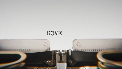 Old mechanical typewriter typing Governance in a close-up view.
