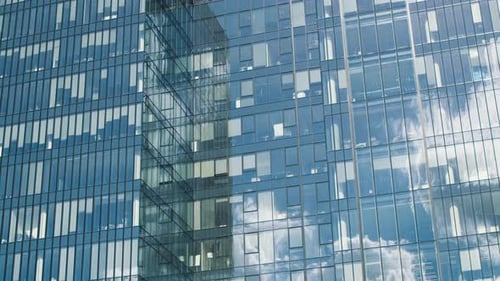 Time Lapse of a Glass Skyscraper with Clouds Reflected in the Office Windows