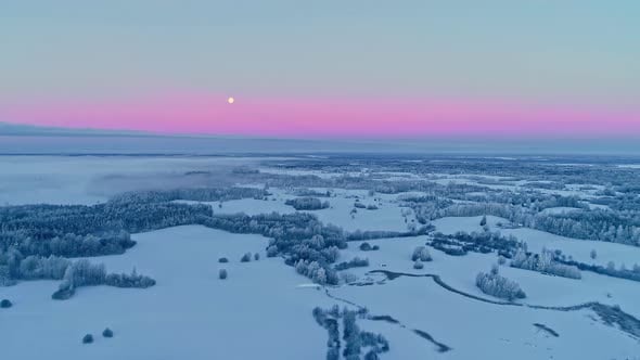 Pink sunset sky after a polar snowstorm. Winter snow landscape, aerial ...