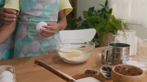 Child Learning to Make Batter for Homemade Pastry and Mom Helping