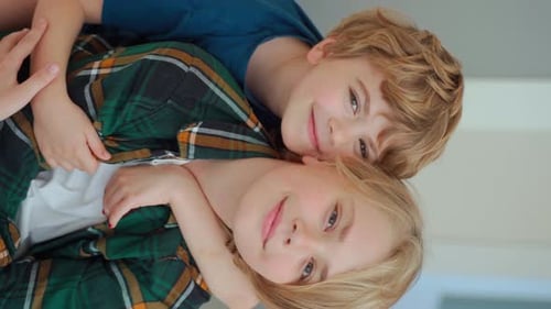 Two Happy Children Embracing Indoors Portrait