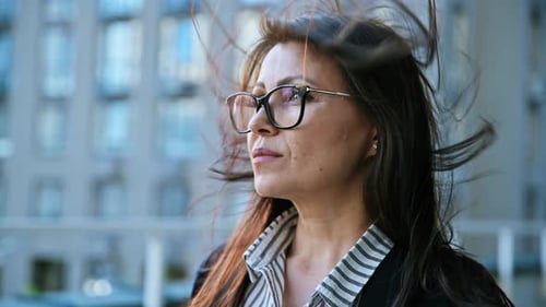 Portrait of Middleaged Beautiful Woman with Hair in the Wind Profile Views