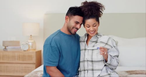 Excited Couple with Positive Pregnancy Test at Home