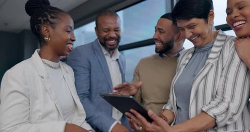 Group of Colleagues Looks at Tablet and Laughs