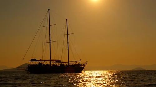 Golden Hour Sailboat Sailing Silhouetted on the Sea
