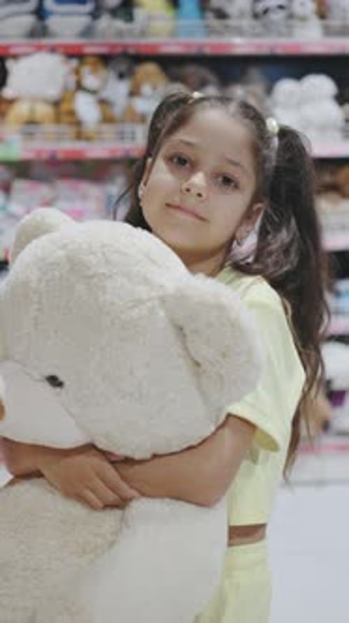 In a Bright and Vibrant Toy Store a Cheerful Young Girl Joyfully Explores the Array of Cute and Soft