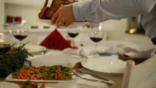 Unrecognizable man serving roasted Turkey during a christmas holiday meal at home