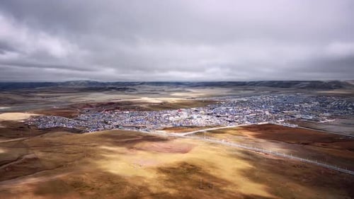 qinghai yushu - Mar 14, 2023: A drone view over the desert town with mountains in the background
