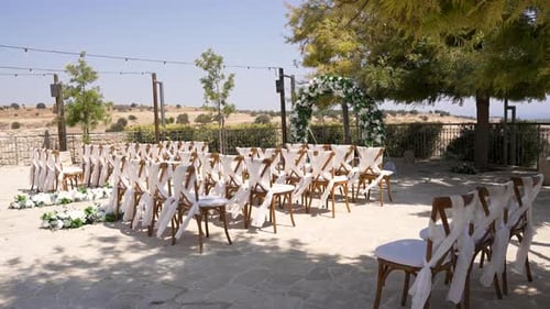 Wedding Ceremony Setup with Arch and White Flowers
