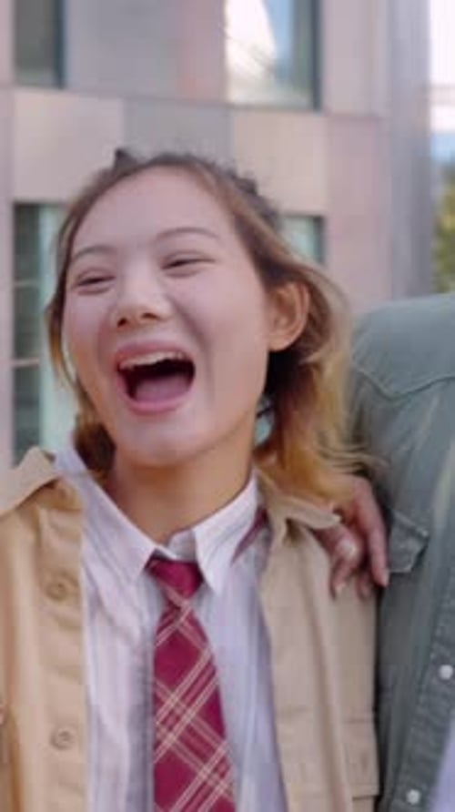 Friends Walking and Laughing Together in City