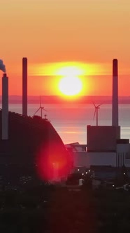 Copenhagen, Denmark - July 24, 2024: Aerial drone view of Amager Bakke in Amager at sunset. Vertical