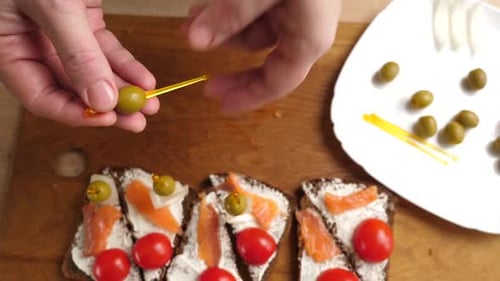 Hand Preparing Delicious Open Sandwiches