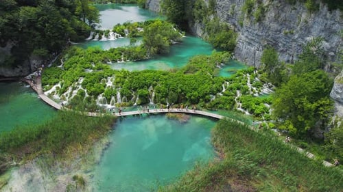 Hiking trail over crystal clear emerald water of lake. Path for tourists in mountain national park w