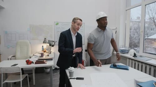 Architects and Engineer Meeting to Discuss Blueprints