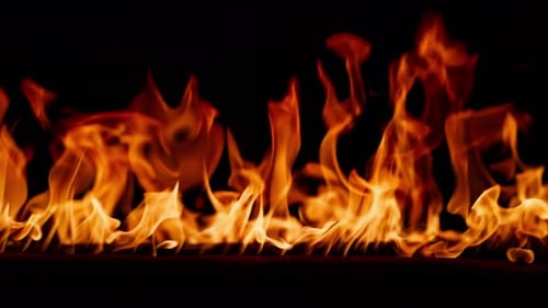 Beautiful Dancing Fire Burning Flame Tongues of Orange Flame Bright Burning Flames on a Black
