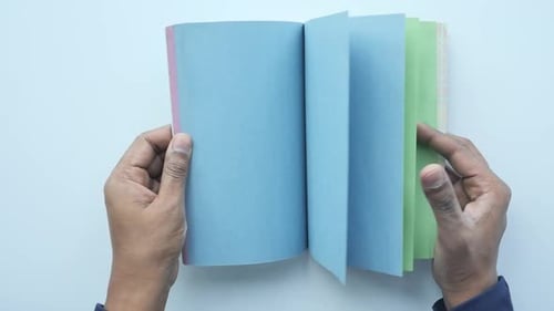 Close Up of Man's Hand Turning a Pager of a Diary