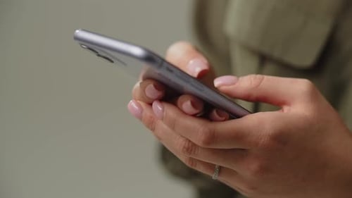 Women's Hands Tap on the Smartphone Screen Cropped View of Woman Typing Something on Her Smartphone
