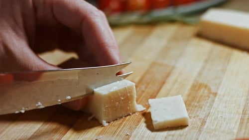 Close Up of Cutting Parmesan Cheese As Appetizer