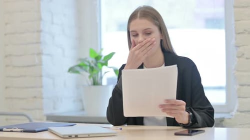 Businesswoman Upset while Reading Documents in Office