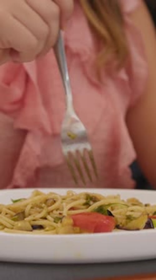 Vegetable Spaghetti Being Twirled onto Fork in Restaurant