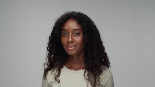 Woman Smiles Beautifully in a Studio Portrait