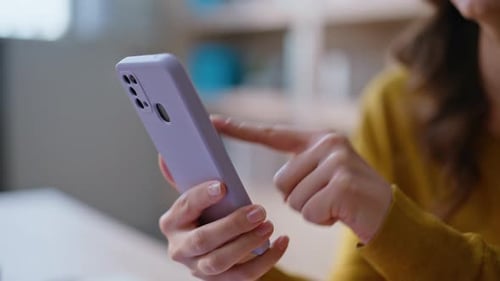 User Hand Pointing Smartphone Searching Information Online at Home Closeup