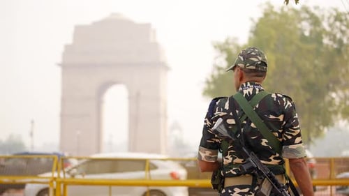 Indian army officer standing in front of India gate