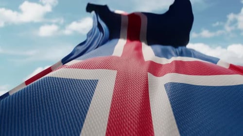 Realistic Waving Iceland Flag Against Blue Sky