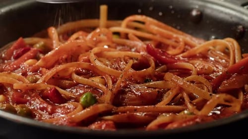 Fresh Pasta Being Seasoned in a Pan