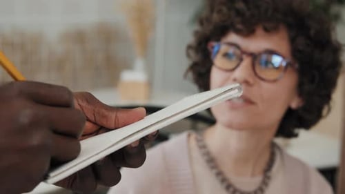 Unrecognizable Waiter Writing Down Order of Caucasian Woman