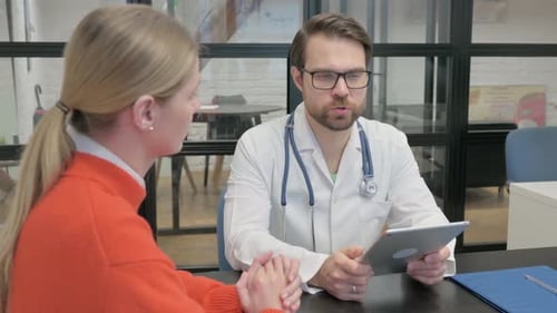 Close up of Doctor Talking with Woman in Clinic