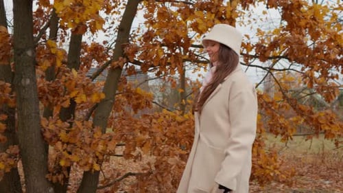 City woman enjoying a peaceful weekend walk in the autumn countryside.