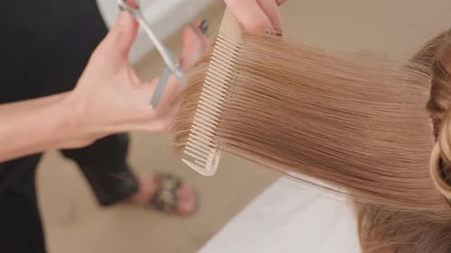 Professional Blond Hair Styling Session Detailed Overhead View of Hairstyling Technique Precise