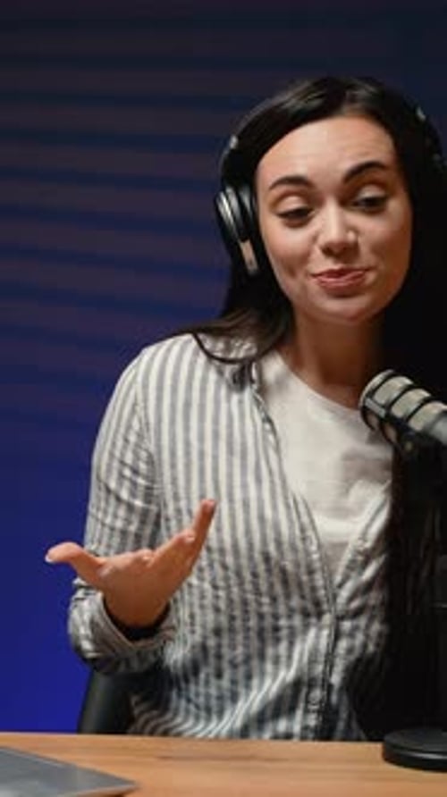 Smiling Woman Talking into Microphone for Video Broadcast