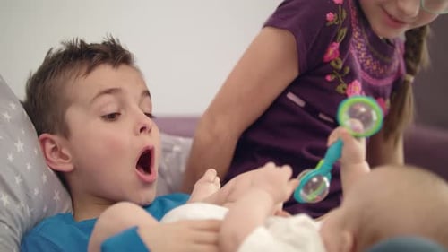 Siblings Playing with Baby. Close Up of Three Children Have Fun At