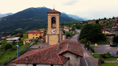 Close-Up of Bell Tower with Clock in Italian Mountain Village in Riva di Solto