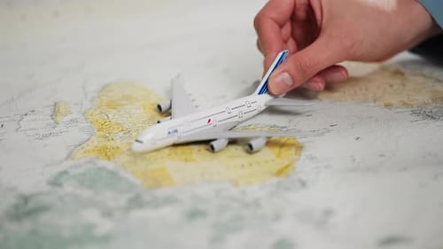 Toy Airplane on World Map for Travel Concept