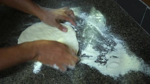 Timelapse of Brown skin man, making homemade pizza dough for baking in new portable pizza oven, Mahe